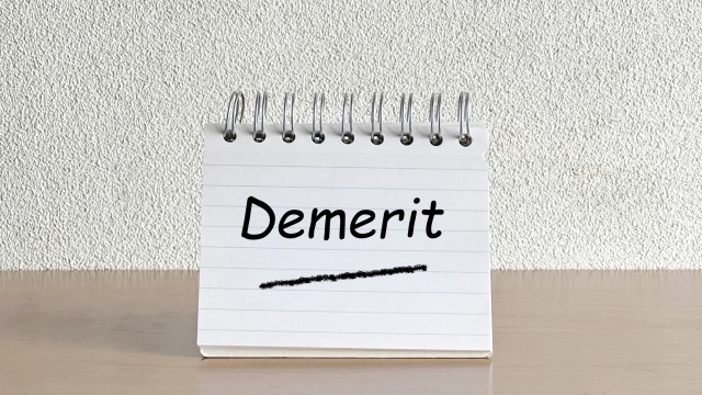 デメリットの文字入りテーブルに立てたメモ帳